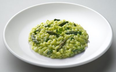 Dish of risotto with asparagus isolated on white plane